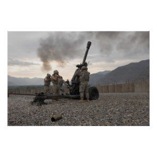 Soldiers fire an M119 Howitzer during training Print