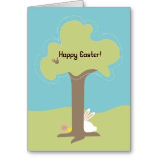 Easter bunny hiding behind tree with eggs greeting cards