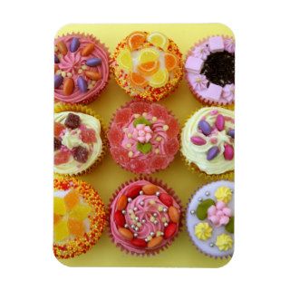 Nine cupcakes each decorated with candy in a rectangular magnet
