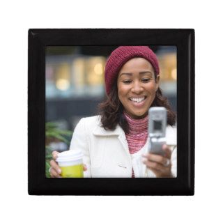 Smiling Business Woman with Cell Phone Gift Boxes