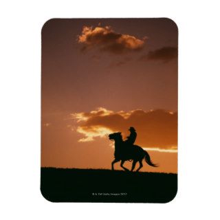 Silhouette of cowboy riding horse at sunset 2 rectangular magnet