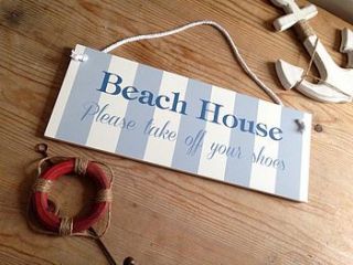 'beach house' wooden sign by the hiding place