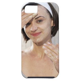 Young woman exfoliating face, smiling, portrait, iPhone 5 covers