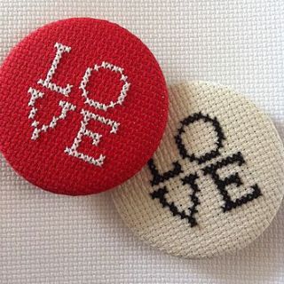 oversized love cross stitch button badge by magasin