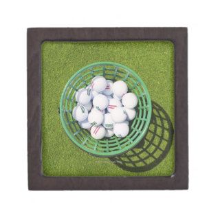 Golf balls in a basket sitting on short green premium keepsake box