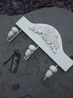 cream ornate coat hook by the hiding place