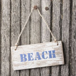 distressed wooden beach style sign by the contemporary home
