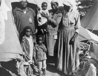 1927 Three African American women with three children in front of tent, durin e1  