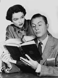 1955 Jane Wyatt looking over Robert Young's shoulder while he is reading a bo a7  