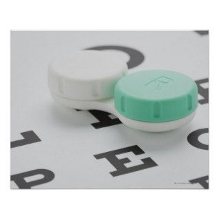 Studio shot of contact lens case on eye chart poster
